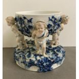 A blue and white porcelain centre bowl on stand with rose and cherub detail