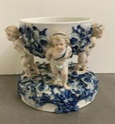 A blue and white porcelain centre bowl on stand with rose and cherub detail