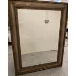 A large gold/silver fleck wooden framed mirror (99cm x 127cm)