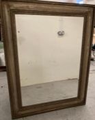 A large gold/silver fleck wooden framed mirror (99cm x 127cm)