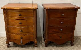 A pair of four drawer bedsides on scrolling feet