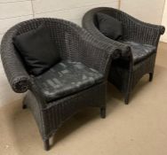 Two painted wicker arm chairs