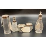 A selection of five silver topped or necked cut glass items