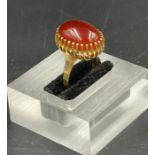 A Carnelian ring set in yellow gold marked 750. (Approximate Total Weight 8.7g) Size M