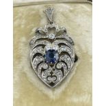 A Heart shaped antique diamond heart pendant with central sapphire