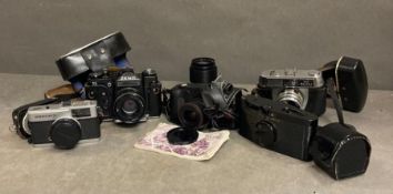 A selection of five vintage cameras to include Halina, Zenit and Purma and a light meter
