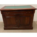 A mahogany desk with green top