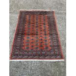 A red ground Bokhara rug (180cm x 130cm)