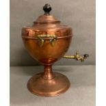 An antique copper tea samovar with a brass tap and handles