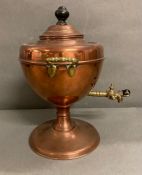 An antique copper tea samovar with a brass tap and handles