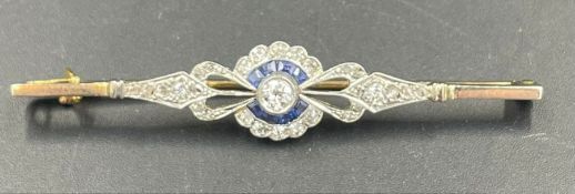 An Antique Diamond brooch, central stone surrounded by six small cut sapphires