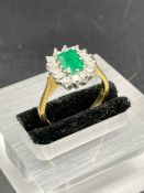 An 18ct yellow gold set emerald and diamond ring Size O