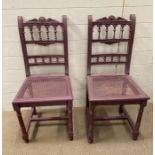 A pair of purple painting wicker seat chairs with empire style legs