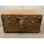 A pine trunk with gilt lion handles