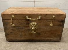 A pine trunk with gilt lion handles