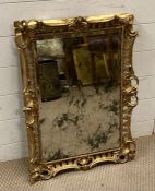 A heavily foxed gilt framed mirror AF (69cm x 48cm)