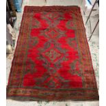 A hand knotted red grounds rug/carpet (214cm x 150cm)