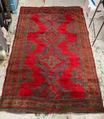 A hand knotted red grounds rug/carpet (214cm x 150cm)