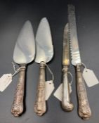 A selection of four silver handled cutlery items, various hallmarks and makers.