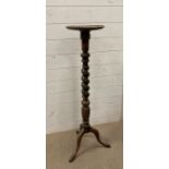 An oak scrolling plant stand on tripod legs with lion paws feet