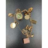 A 9ct gold charm bracelet with assorted charms (Approximate Total weight 26.5g)