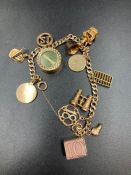 A 9ct gold charm bracelet with assorted charms (Approximate Total weight 26.5g)