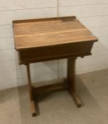A vintage light oak school desk