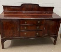 A mahogany sideboard on bracket feet, drawers to centre and flanked by cupboards (H129cm W169cm