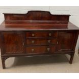 A mahogany sideboard on bracket feet, drawers to centre and flanked by cupboards (H129cm W169cm