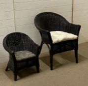 A black painted wicker arm chair and a child's black painted wicker arm chair