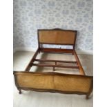 A 5ft mahogany and cane bed frame