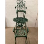 A wrought iron painted green bistro set