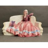 A Katzhutte porcelain figure of a lady on a couch