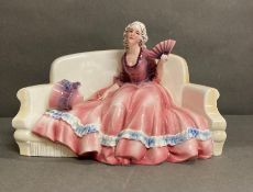 A Katzhutte porcelain figure of a lady on a couch