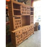 A light oak four drawer, seven cupboard dresser (W200cm D40cm H200cm)