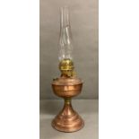 A vintage copper and brass oil lamp