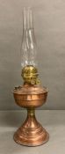 A vintage copper and brass oil lamp