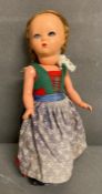 A vintage German doll in traditional dress