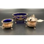 Three silver cruets with blue glass liners, various styles, makers and hallmarks