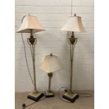 A pair of contemporary floor lamps and a matching table lamp with urn details