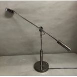 A chrome counter weight desk lamp
