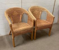 A pair of wicker armchairs