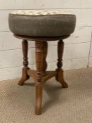 A light oak upholstered adjust piano stool on splayed legs (Dia35cm H50cm)
