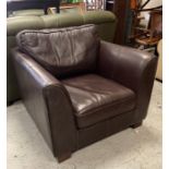 A Brown leather lounge chair on wooden block feet