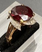 A ruby and diamond ring in an 18ct gold setting (Approximate Size N1/2)