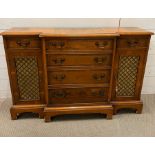 A small breakfront side cabinet with four centre drawers flanked by cupboards (76cm H x D 34 cm x
