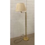 A brass adjustable floor standing lamp