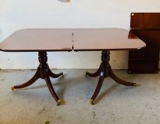 A twin pedestal mahogany dining table with extra leaf (H77cm D100cm W164cm EX50cm)