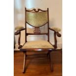 An arts and crafts style folding parlour / campaign chair with upholstered back and seat