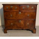 A walnut two over two chest of drawers with brass drop handles AF (H74cm W80cm D42cm)